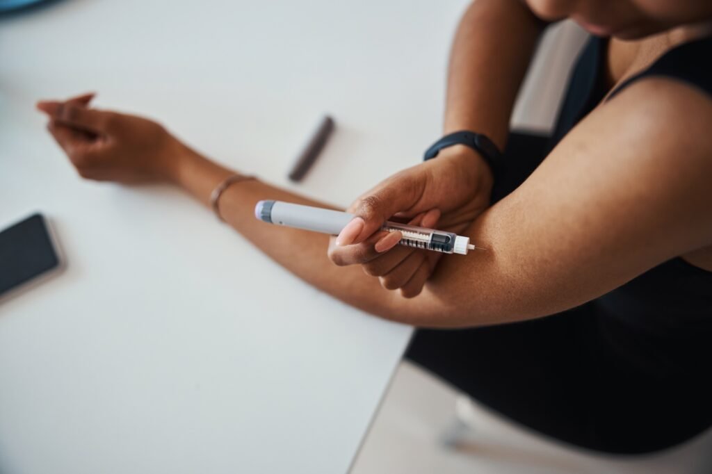 Afro American young woman doing vitamin injection
